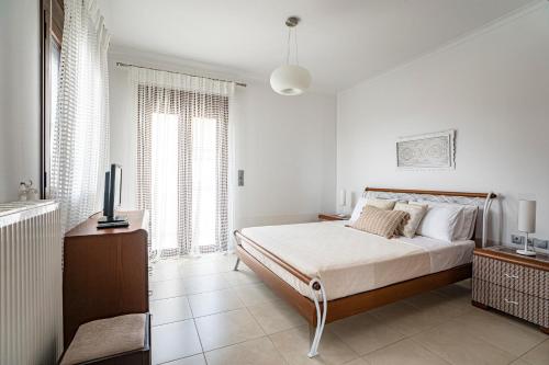 Ένα ή περισσότερα κρεβάτια σε δωμάτιο στο Krissa Villa