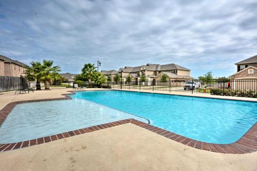 a large blue swimming pool in a apartment complex at College Station Townhouse with Private Patio in College Station