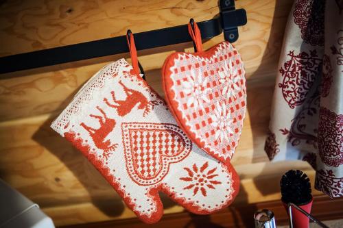two knitted mittens are hanging on a rack at Zruby Bystrá, Chopok Juh in Bystrá