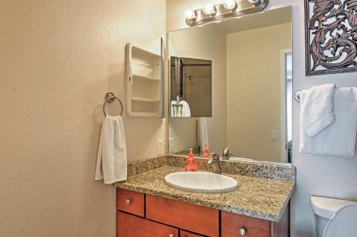 a bathroom with a sink and a mirror at Las Vegas Condo with Patio, Pool, Gym about 1 Mi to Strip in Las Vegas