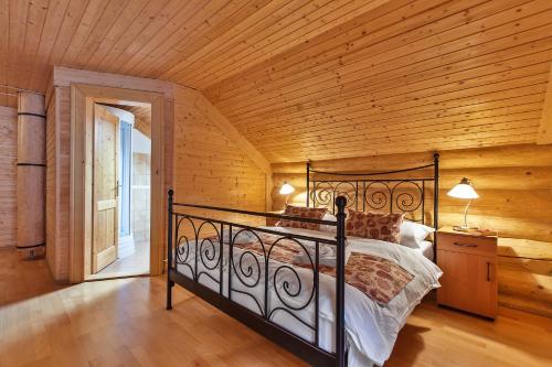 a bedroom with a bed in a room with wooden walls at Zruby Bystrá, Chopok Juh in Bystrá