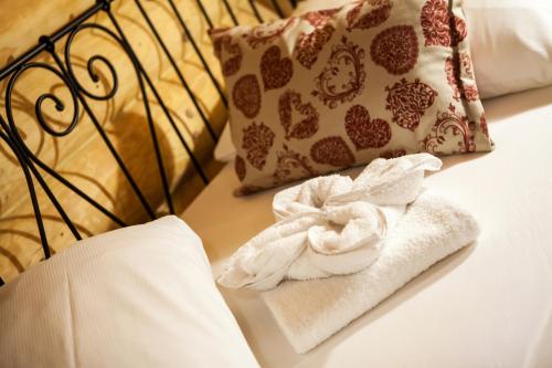a pile of towels sitting on a bed with pillows at Zruby Bystrá, Chopok Juh in Bystrá
