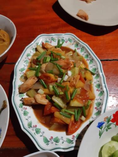 a bowl of soup with shrimp and green onions at Som PalmGarden in Ko Lanta