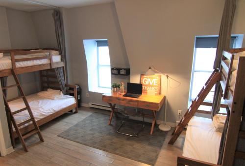 a dorm room with a desk and a laptop on it at The Clarence Park in Toronto