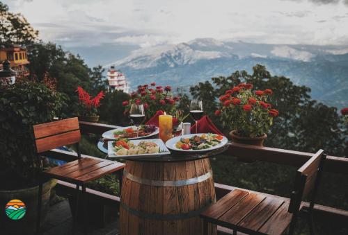 a table with two plates of food on top of a mountain at Hotel Country Villa in Nagarkot
