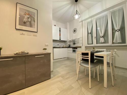 a kitchen and dining room with a table and chairs at GUEST HOUSE KINGA in Florence