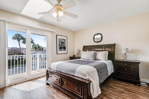 a bedroom with a bed and a ceiling fan at Woodland Shores in Destin