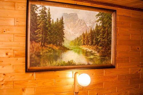 a painting of a river on a wall at Smerekova Hata in Yablunytsya