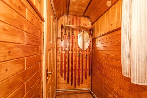 a home hallway with wood paneled walls and a door at Smerekova Hata in Yablunytsya