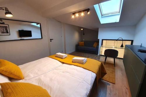 sypialnia z dużym łóżkiem i żółtym kocem w obiekcie Duplex apartment Morsztynowska w Krakowie
