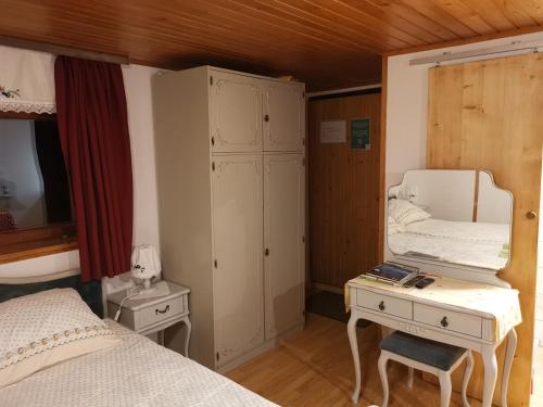 a bedroom with a bed and a dresser and a bed and a desk at Apartment Zalokar in Bohinj