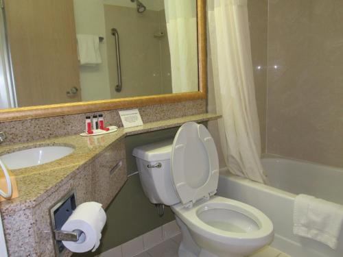 a bathroom with a toilet and a sink at Super 8 by Wyndham New Cumberland in New Cumberland