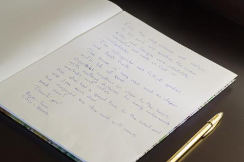 a book with a pen on a table at Manolia Dream Apartment 3-bedrooms 30m to the beach in Agia Marina Nea Kydonias