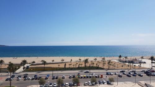 a parking lot next to the beach with cars parked at Ampuries Delta Apartment in Empuriabrava