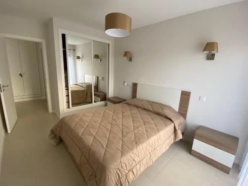 a bedroom with a bed and a large mirror at Albur Village B - Lotus in Alvor