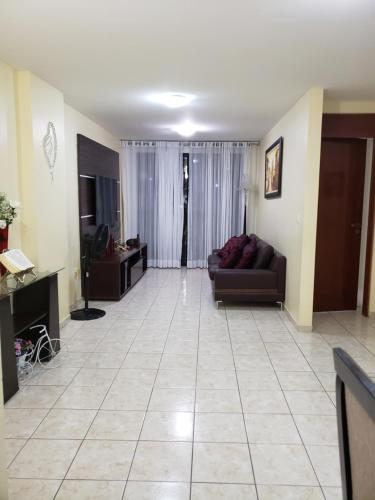 a living room with a couch and a table at Apartamento na praia de Manaira in João Pessoa