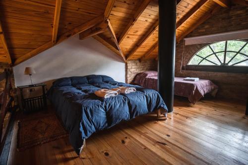 a bedroom with a large bed in a attic at Los Catires in Sierra de la Ventana