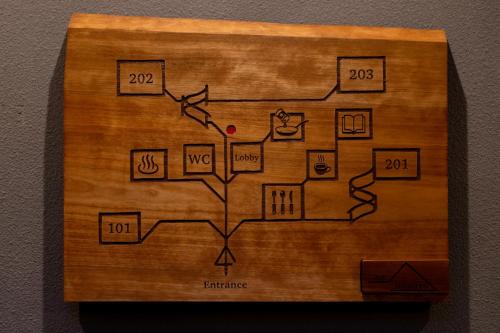 a wooden block with a diagram of a tree at inn NOSHIYU in Minamioguni