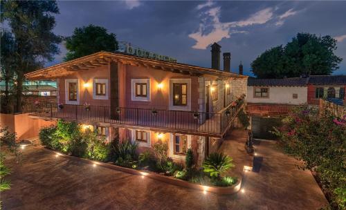 an image of a house at night with lights at Hotel Morelia Boutique Villa Italia in Morelia
