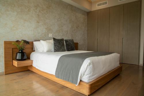 a bedroom with a large bed with a wooden headboard at Santa Fe Paradox Premier apt 2 bedrooms 4 guests 3403 in Mexico City