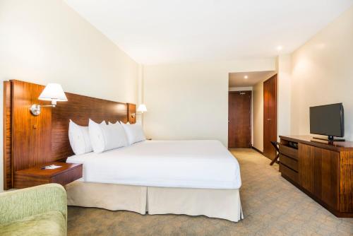 a hotel room with a bed and a television at Holiday Inn Express Quito by IHG in Quito