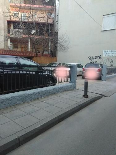 a car with its lights on driving down a street at Hotel Elena in Edessa