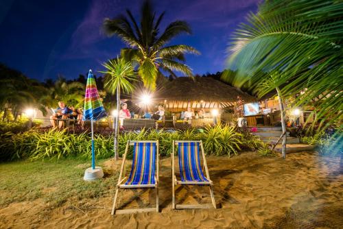 two chairs on the beach at night at Serenity Resort Koh Chang in Ko Chang