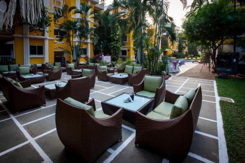 a restaurant with chairs and tables in a courtyard at Adamo The Bellus Calangute in Calangute