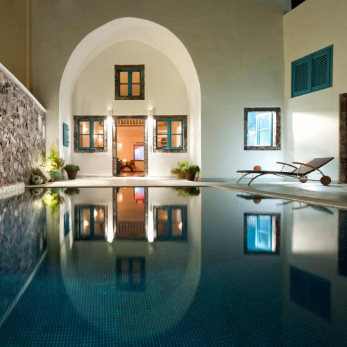 an infinity pool in a home with a house at Vallas Apartments & Villas in Firostefani