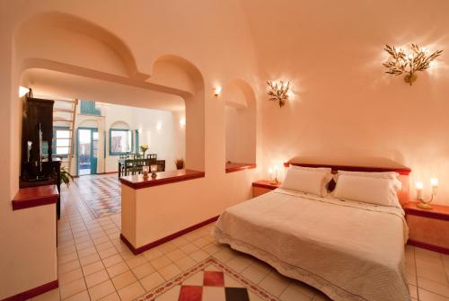 a bedroom with a bed in a room at Vallas Apartments & Villas in Firostefani