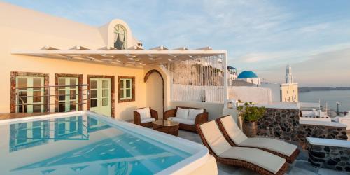 a villa with a swimming pool on a roof at Vallas Apartments & Villas in Firostefani