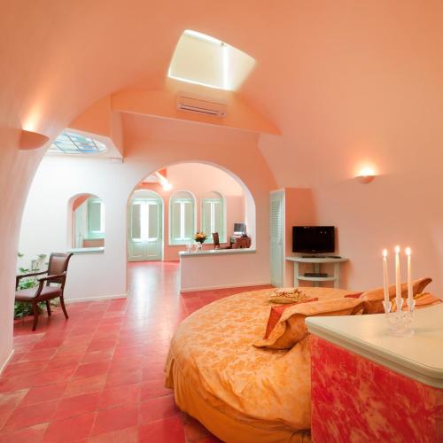 a bedroom with a large bed in a room at Vallas Apartments & Villas in Firostefani