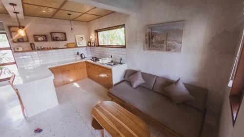 a living room with a couch and a sink at Little Ripper Boutique Lofts in Tanah Lot