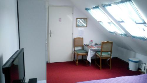 a dining room with a table and chairs and a window at Rooms IVKA in Plitvička Jezera