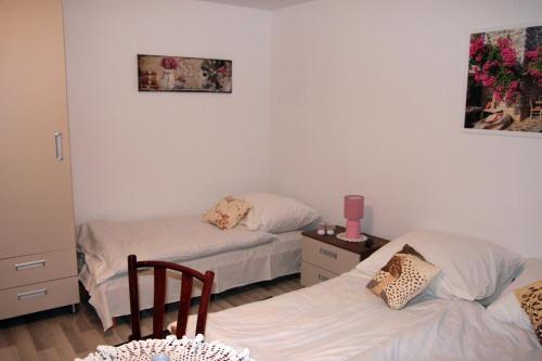 a bedroom with two beds and a table at Apartament U Jacka 2 in Rabka