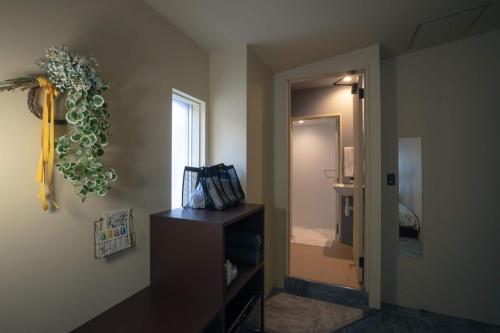 a room with a bathroom with a sink and a mirror at Hotel Trim in Kanazawa