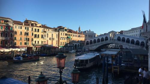 a bridge over a river with boats in a city at EGO' Boutique Hotel - The Silk Road in Venice
