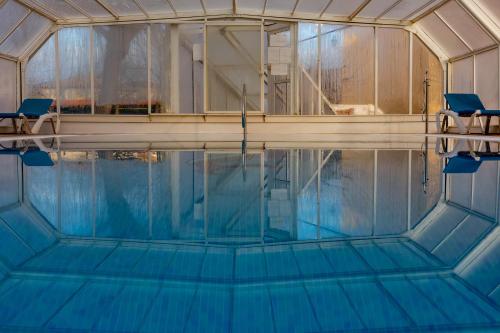 an overhead view of a swimming pool with two chairs at Hotel de Montaña Rubielos in Rubielos de Mora