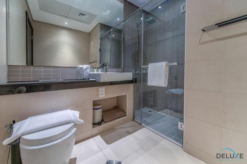 a bathroom with a toilet and a sink and a shower at Neat 2BR at Silverine Tower Dubai Marina by Deluxe Holiday Homes in Dubai