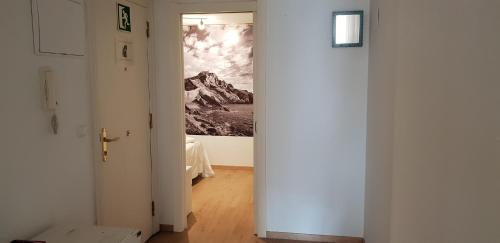a hallway with a painting of a mountain at Apartamentos Bermeo, Museoa in Bermeo