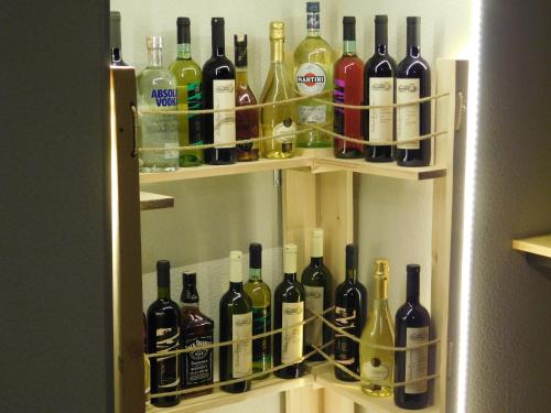 a refrigerator filled with lots of bottles of wine at Tea for Two Hotel in Tbilisi City