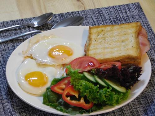 a plate of breakfast food with eggs and toast at Tea for Two Hotel in Tbilisi City