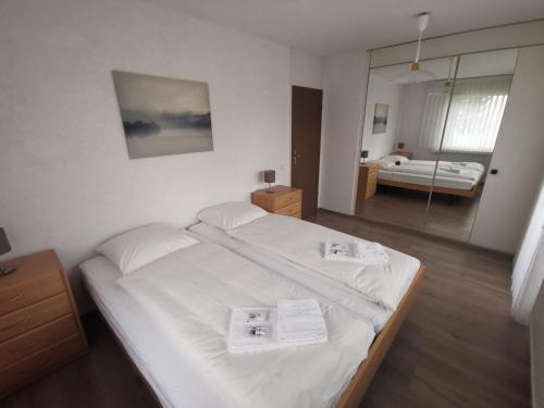 a bedroom with a bed with two towels on it at Appartementhaus-Quadern in Valens