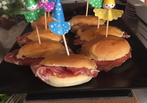 a group of sandwiches on a black plate with flags at Hotel Storyville - svago e convenzioni aziendali in Cinquale