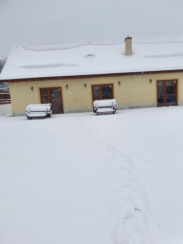a building with snow on top of it at Bobrówka in Solina