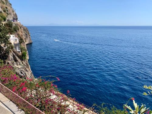 a view of the ocean from the side of a cliff at Villa Le Baste in Furore