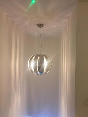 a silver light fixture hanging from a ceiling at Alderberry Lodge in Newquay