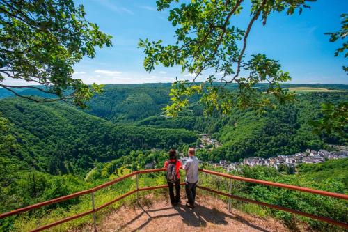 a man and woman standing on top of a mountain overlooking a valley at Haus am Berg in Bad Bertrich
