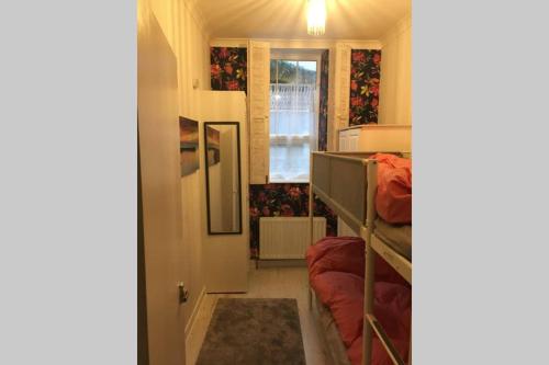 a small room with a bunk bed and a hallway at Cathedral apartment in Derry Londonderry