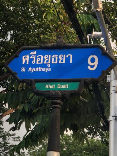 a blue street sign on top of a pole at Baan Tepa Boutique House in Bangkok